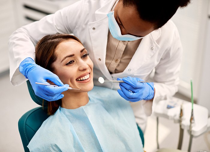 Woman in dental chair with dentist about to start her exam