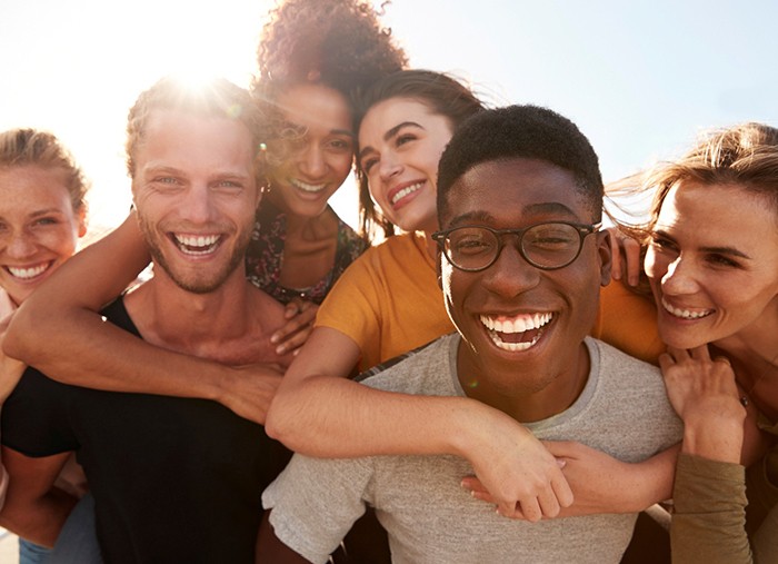 Group of friends smiling after visiting their Delta Dental dentist in Shelby Township