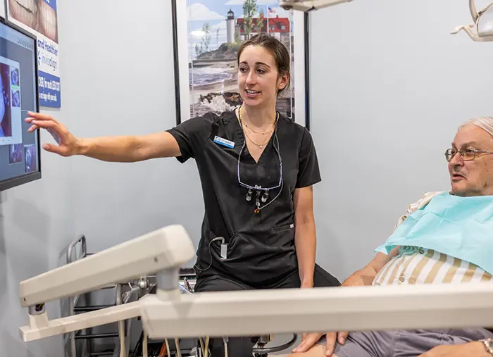 Female dentist treating patient in dental chair