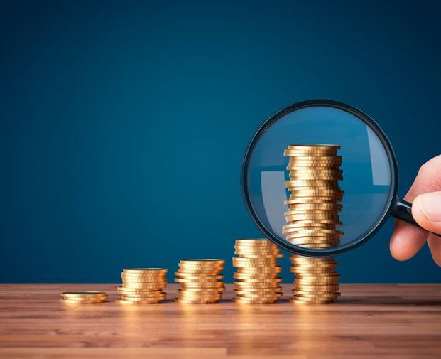 Stacks of coins examined with magnifying glass